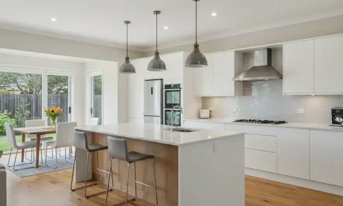 Modern kitchen with open layout, island bench, and sleek finishes.