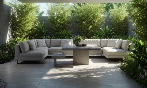 Stylish outdoor lounge with modern sectional seating, light cushions, dining table, and lush greenery in a sleek, minimalist setting.